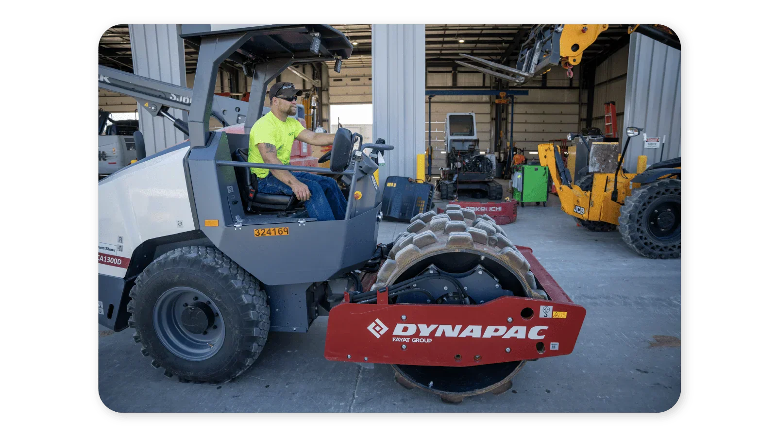 Driver operating a single drum padfoot roller.