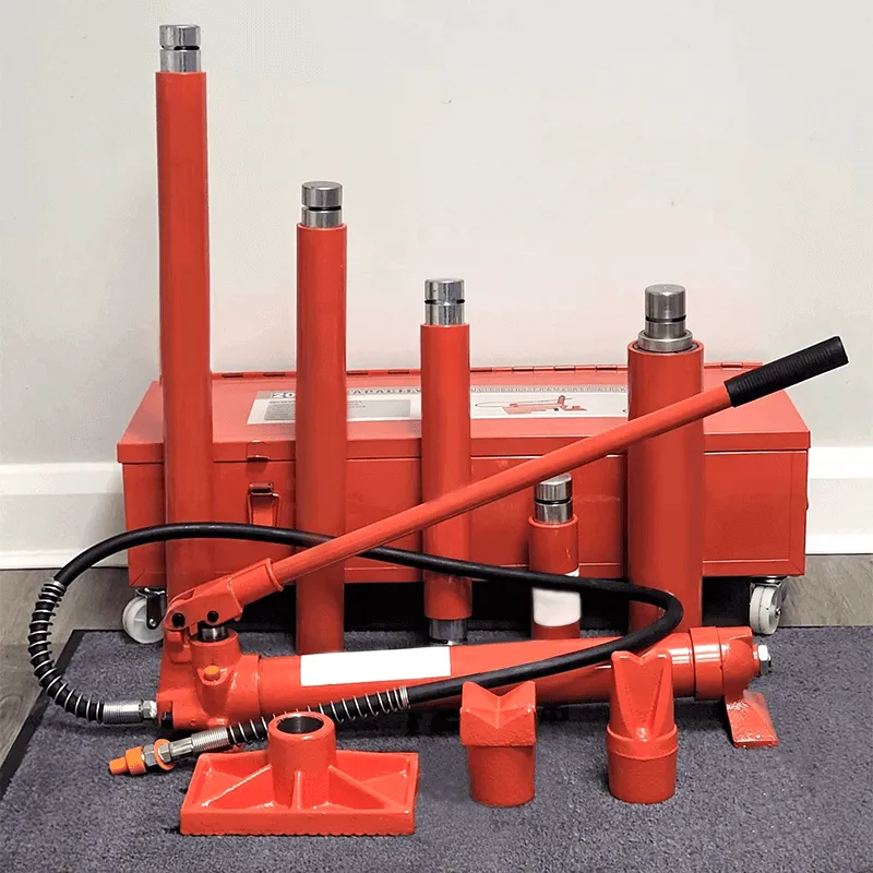 A complete red Porta Power hydraulic kit with a pump, hose, and various ram attachments laid out in front of its metal toolbox.